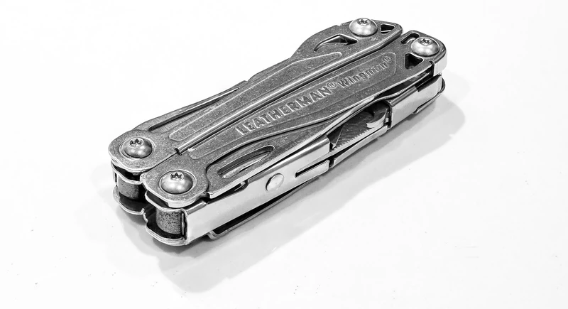 Leatherman Wingman multi-tool, closed, with the Leatherman and Wingman names engraved on the stainless handle.